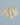 Cream-colored shorts with a black polka dot pattern, featuring an elastic waistband, laid flat on a light blue textured background.